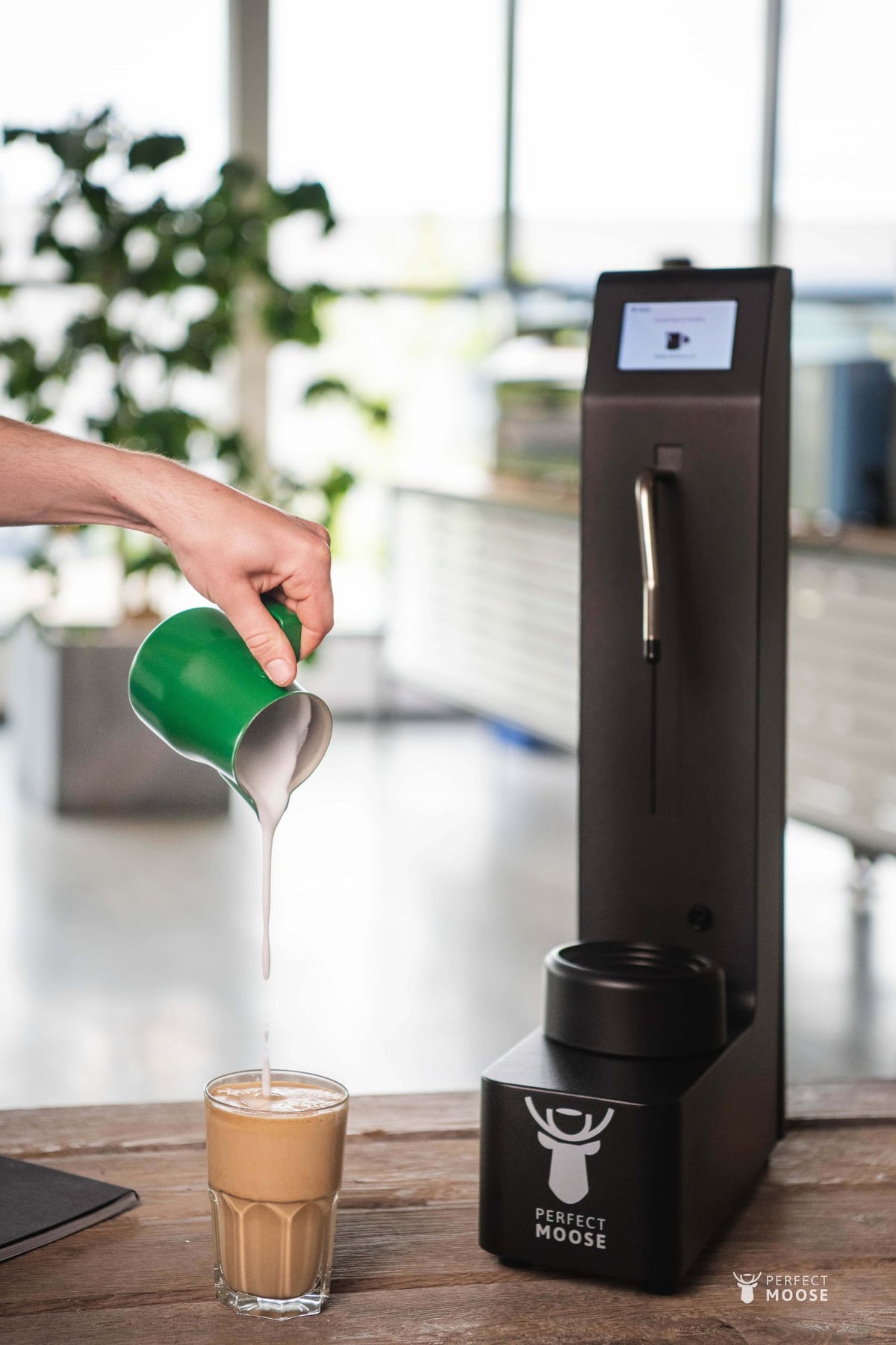 Plant milk poured from a green Smart Jug beside Perfect Moose