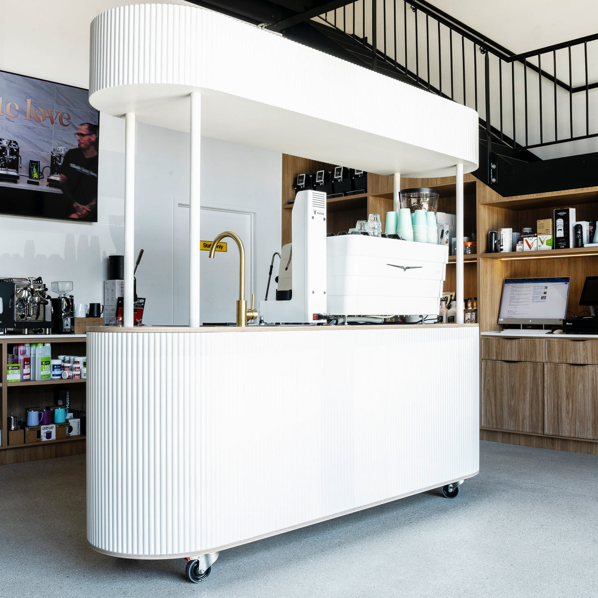 White coffee cart with an espresso machine in the Barista Equip showroom